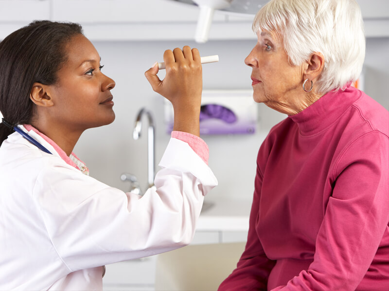 female doctor checking patients eyes