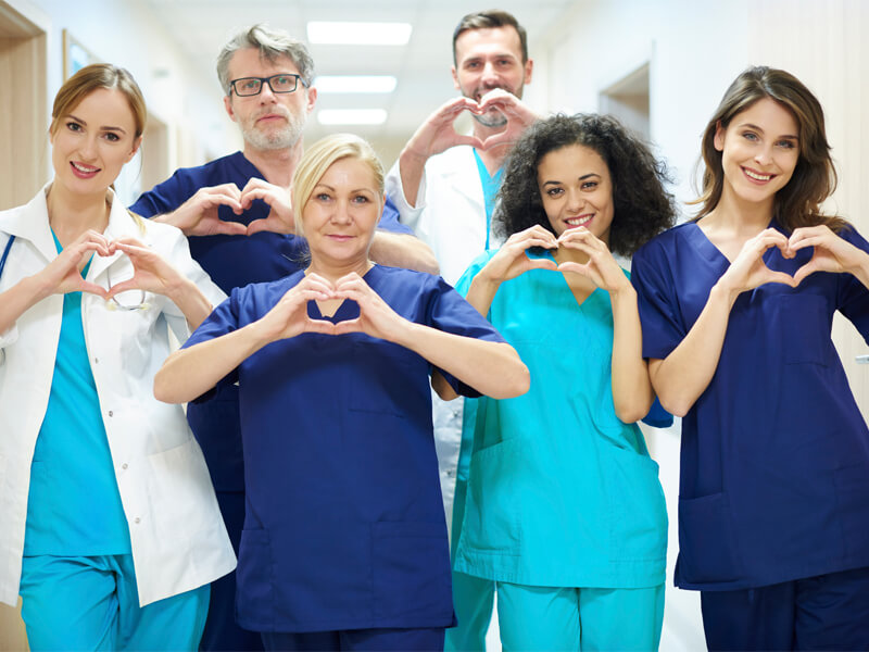 health workers making heart sign with hands
